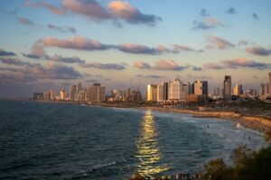 a view of a beach with a city in the background